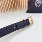 Dark blue leather belt with gold buckle and small stud holes on the strap