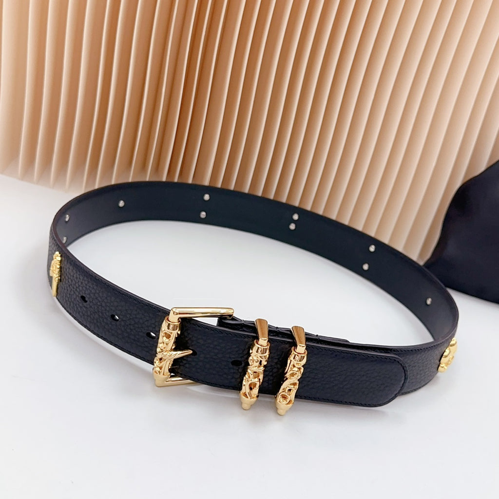 Dark blue leather belt with gold buckle and decorative charms along the strap
