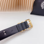 Navy leather belt buckle with gold hardware and cross engraving, close-up