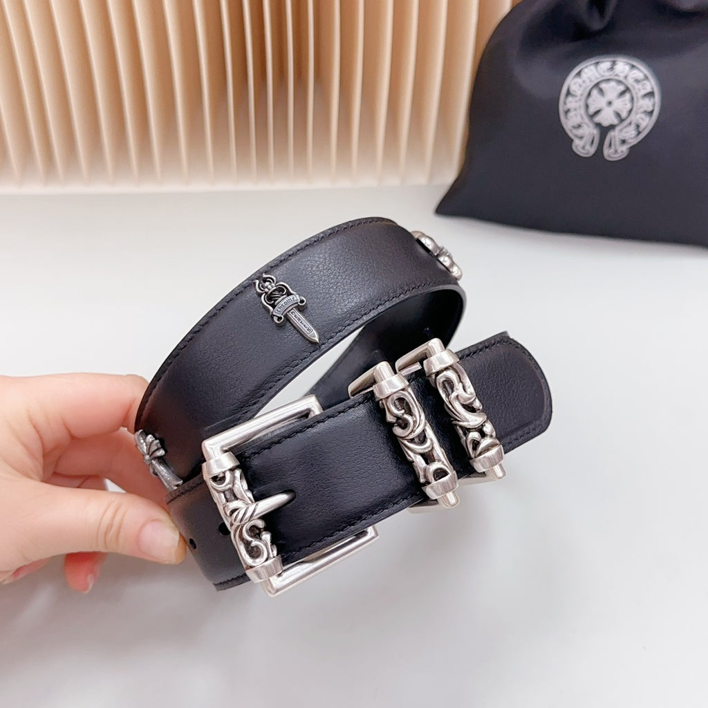 Dark leather belt close-up with chrome buckle and chain hardware, studded holes