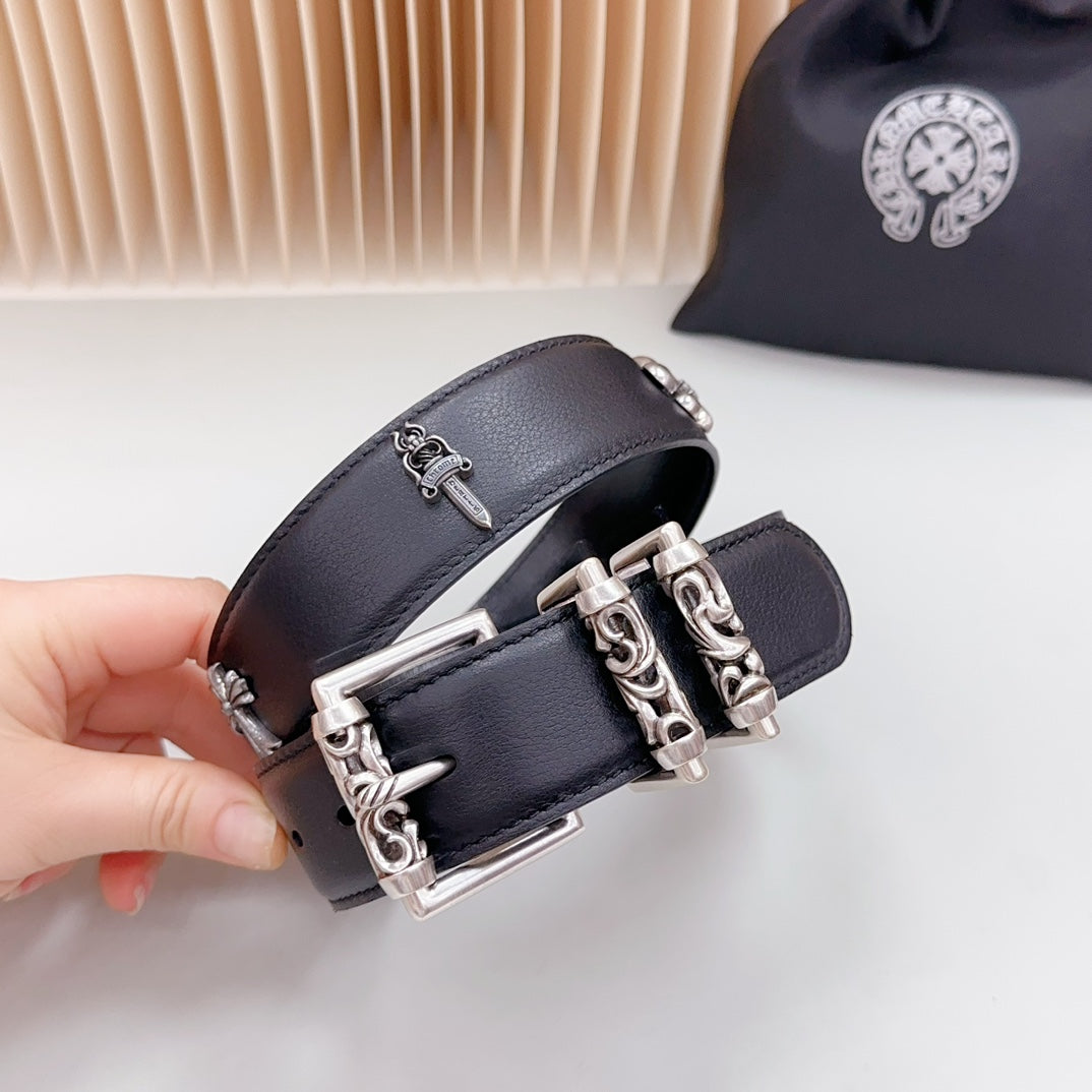 Dark leather belt close-up with chrome buckle and chain hardware, studded holes