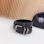 Dark leather belt with chrome buckle and chain hardware, metal studs
