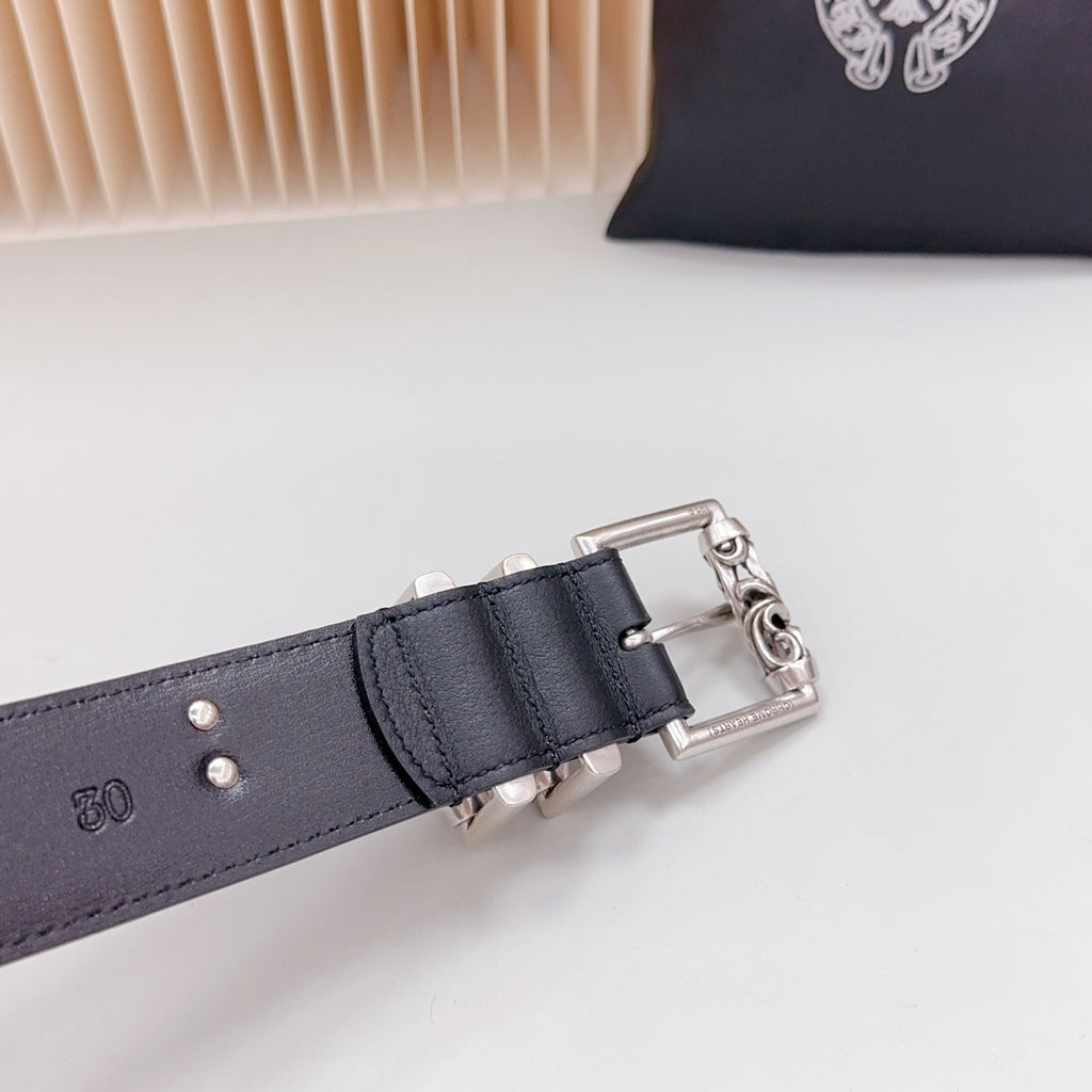 Dark leather belt end with chrome rectangular buckle and chain links