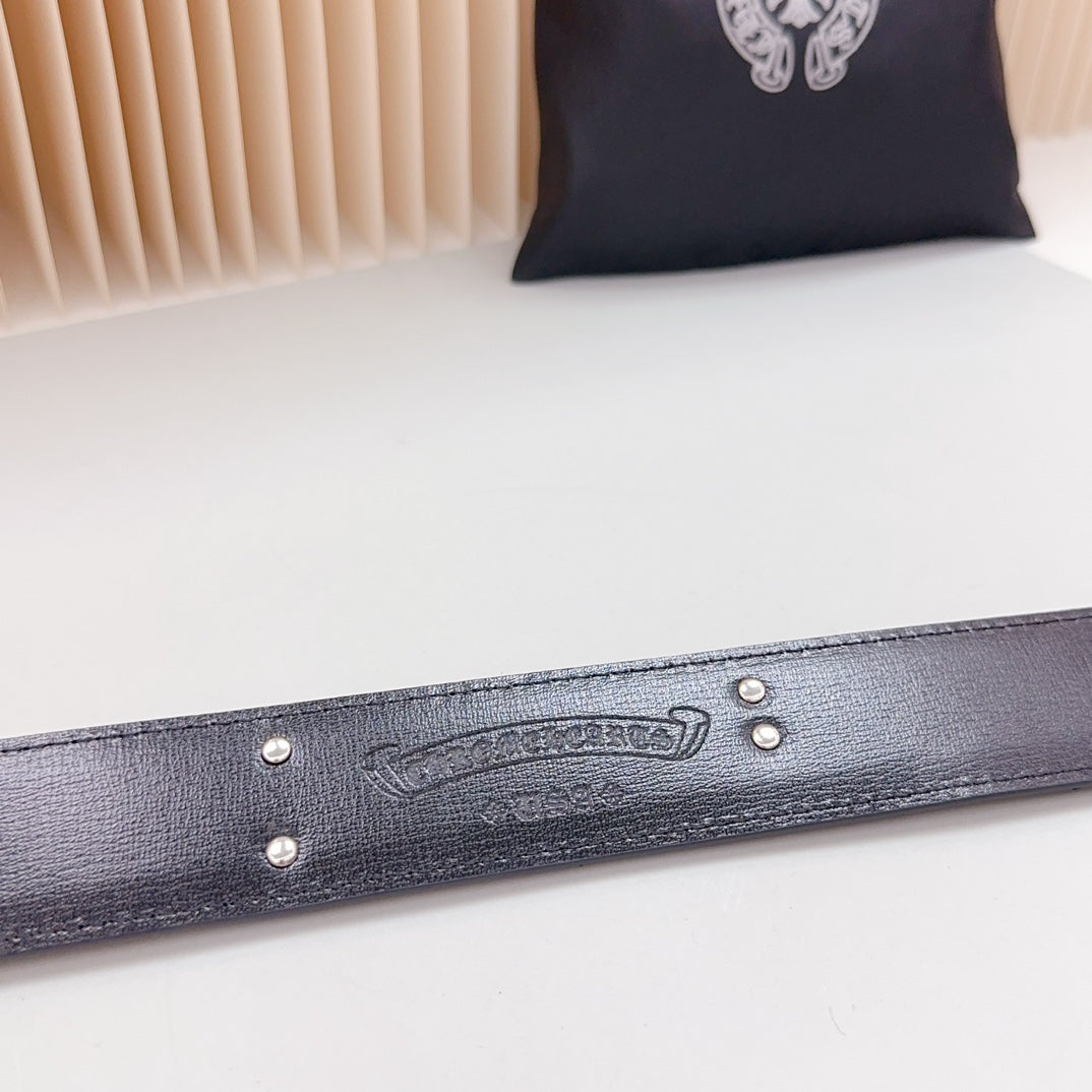 Dark leather belt with engraved emblem and metal stud accents