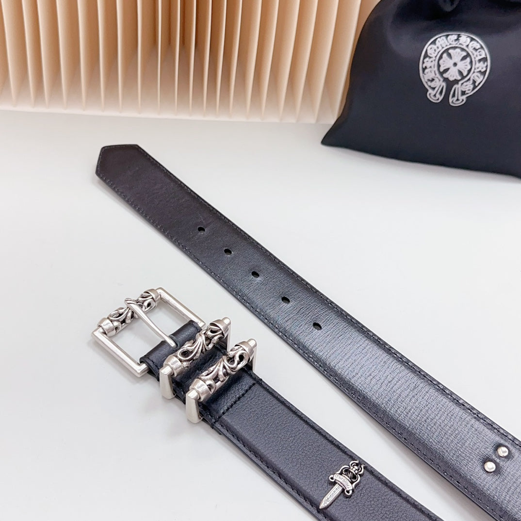 Dark belt strap with chrome keeper buckle, button holes, and hardware pieces laid flat