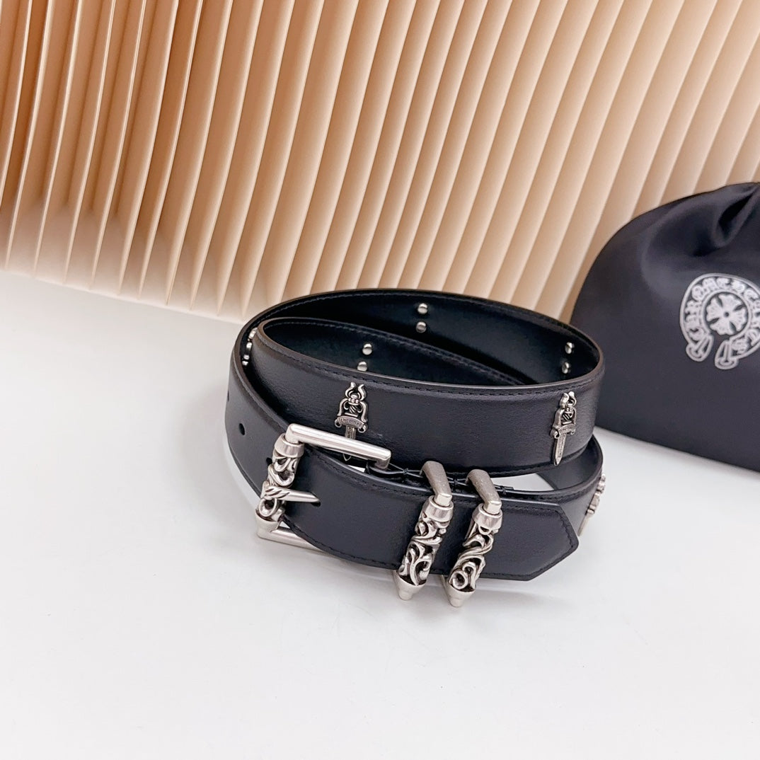 Dark leather-look belt with chrome buckle hardware and charm details across strap