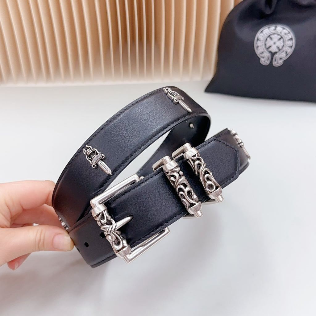 Dark belt strap detail with chrome buckle and decorative hardware, close-up view