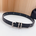 Belt with dark leather-look strap and chrome buckle with decorative studs