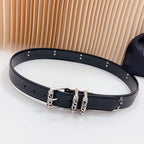 Belt with dark leather-look strap and chrome buckle with decorative studs