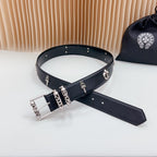 Chrome belt with silver buckle and decorative charms, flat lay with stud row along edge