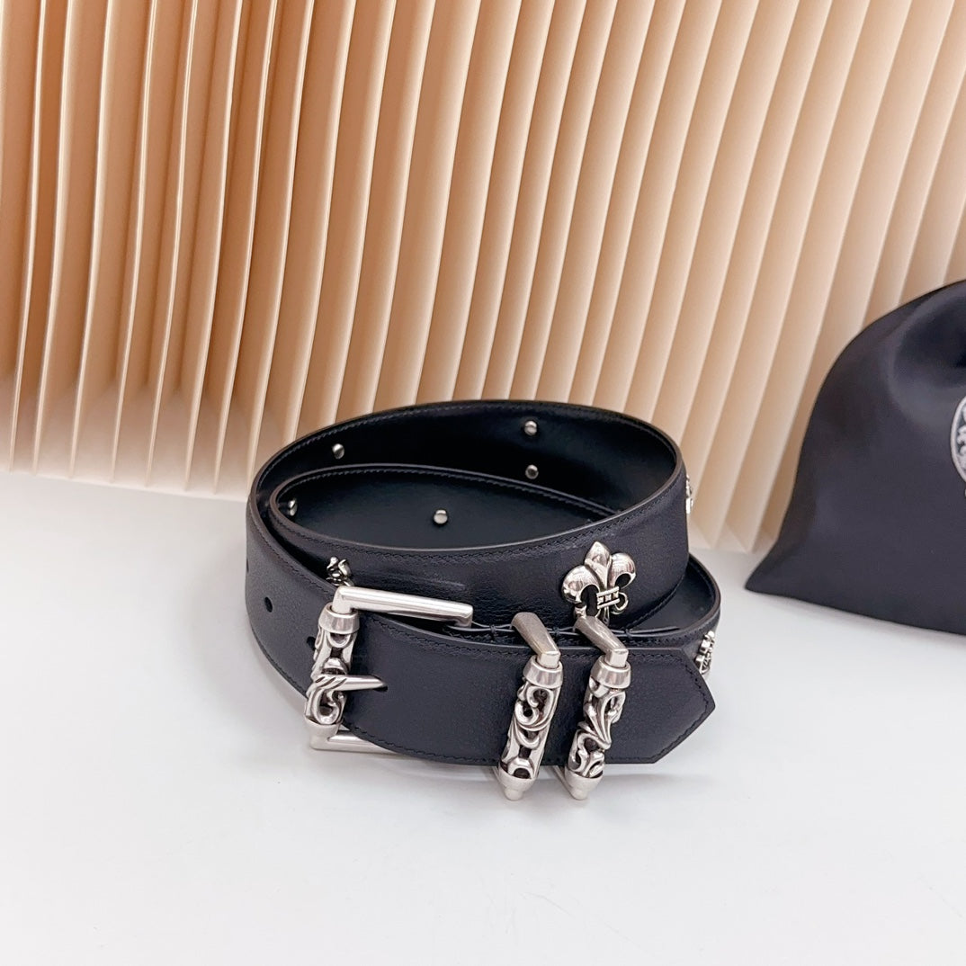 Chrome belt rolled view with silver buckles and chain-like charm accents on dark leather