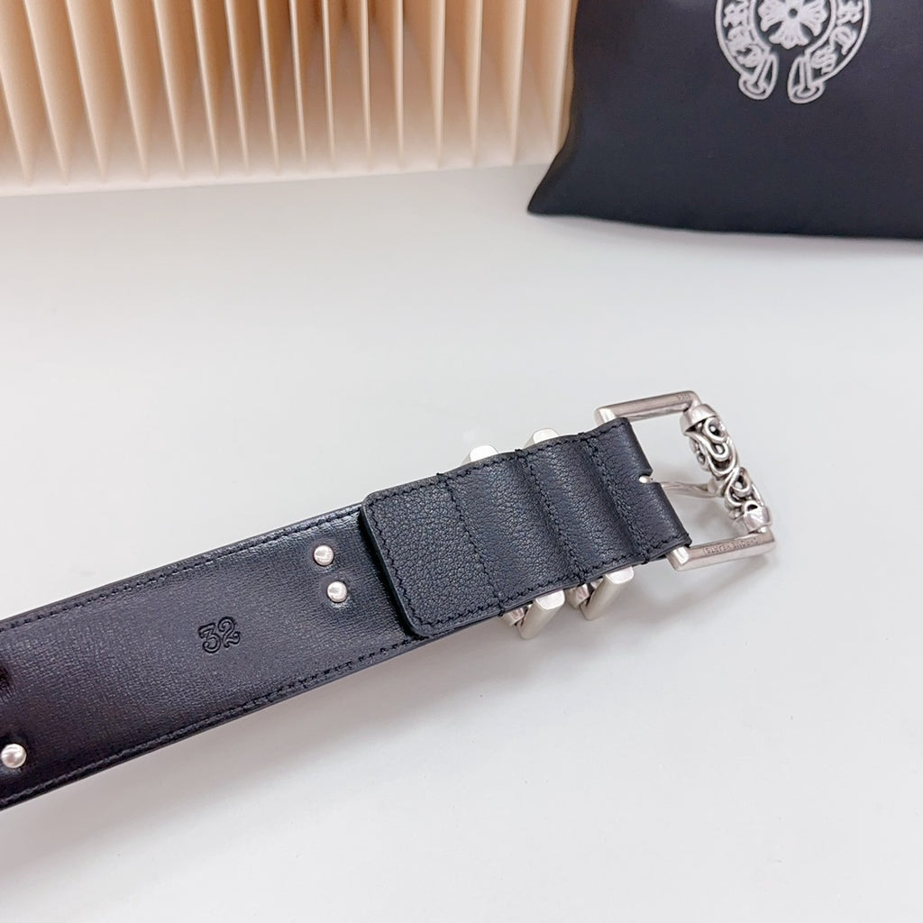Chrome belt end section with silver buckle frame, dark leather strap and keeper tab