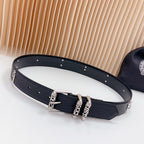 Chrome belt with dark leather and silver buckles, stud trim, and cross charm detail