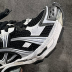 Unisex sneakers side close-up with black mesh, white trim stripes, chunky sole.