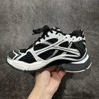 Unisex sneakers with black and white panels, lace-up front, thick cushioned sole.