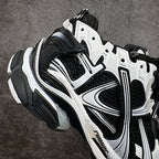 Unisex sneakers angled side view with black mesh, white overlays, lace-up and thick sole.