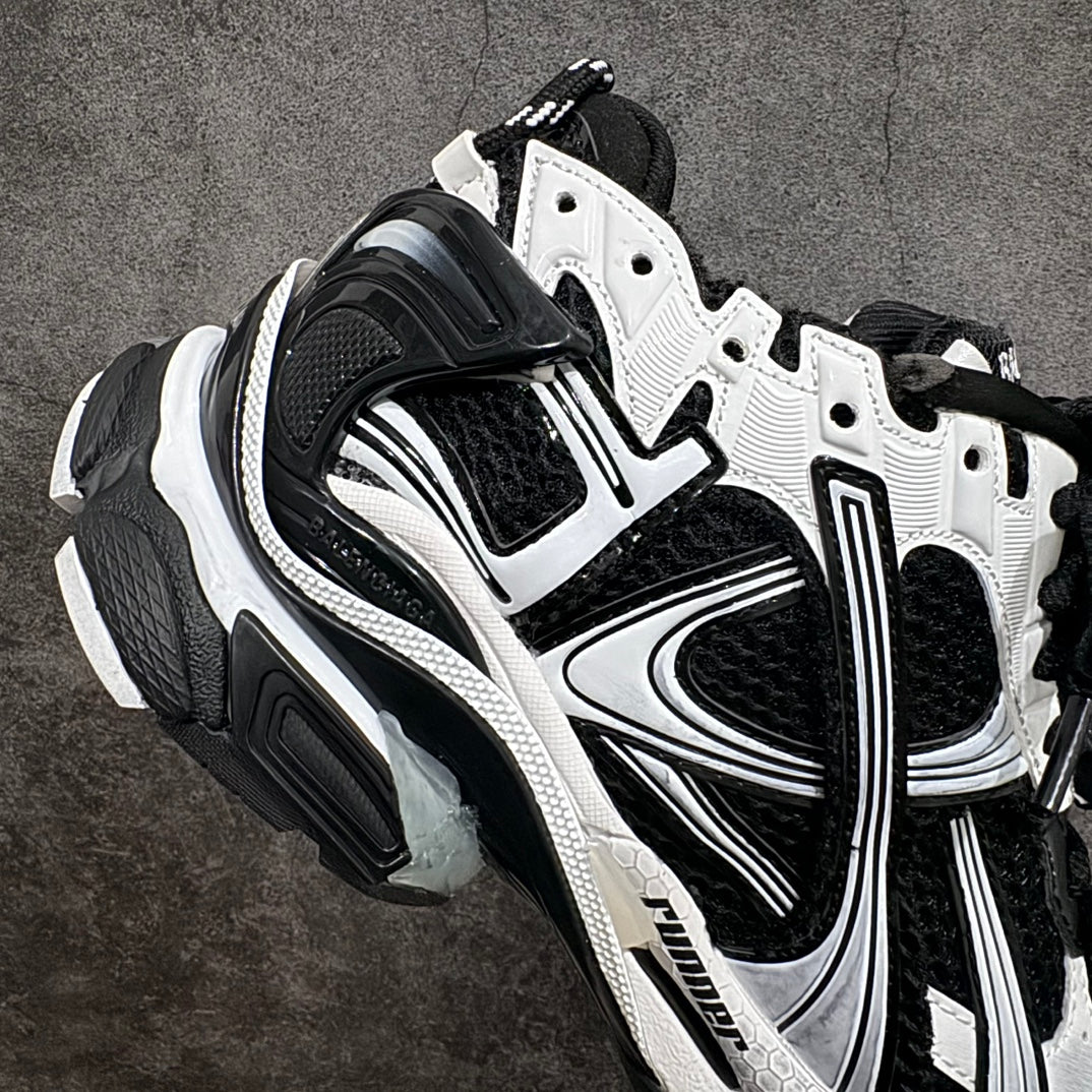 Unisex sneakers angled side view with black mesh, white overlays, lace-up and thick sole.