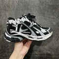 Unisex sneakers with black and white uppers, lace-up design, chunky rubber sole.