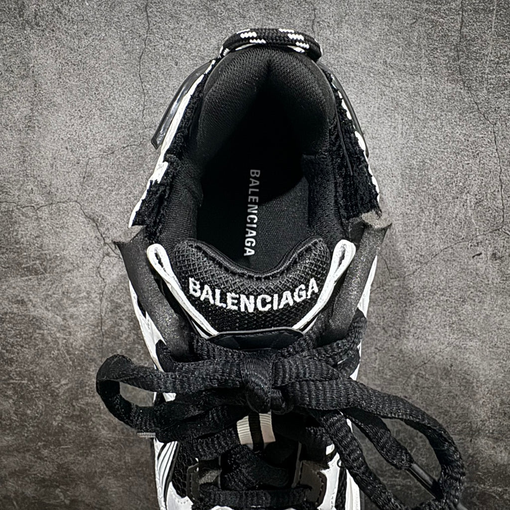 Unisex sneakers heel close-up with BALENCIAGA logo on insole, black laces.