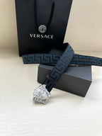 Versace belt showing silver buckle and long dark blue Greek key strap.