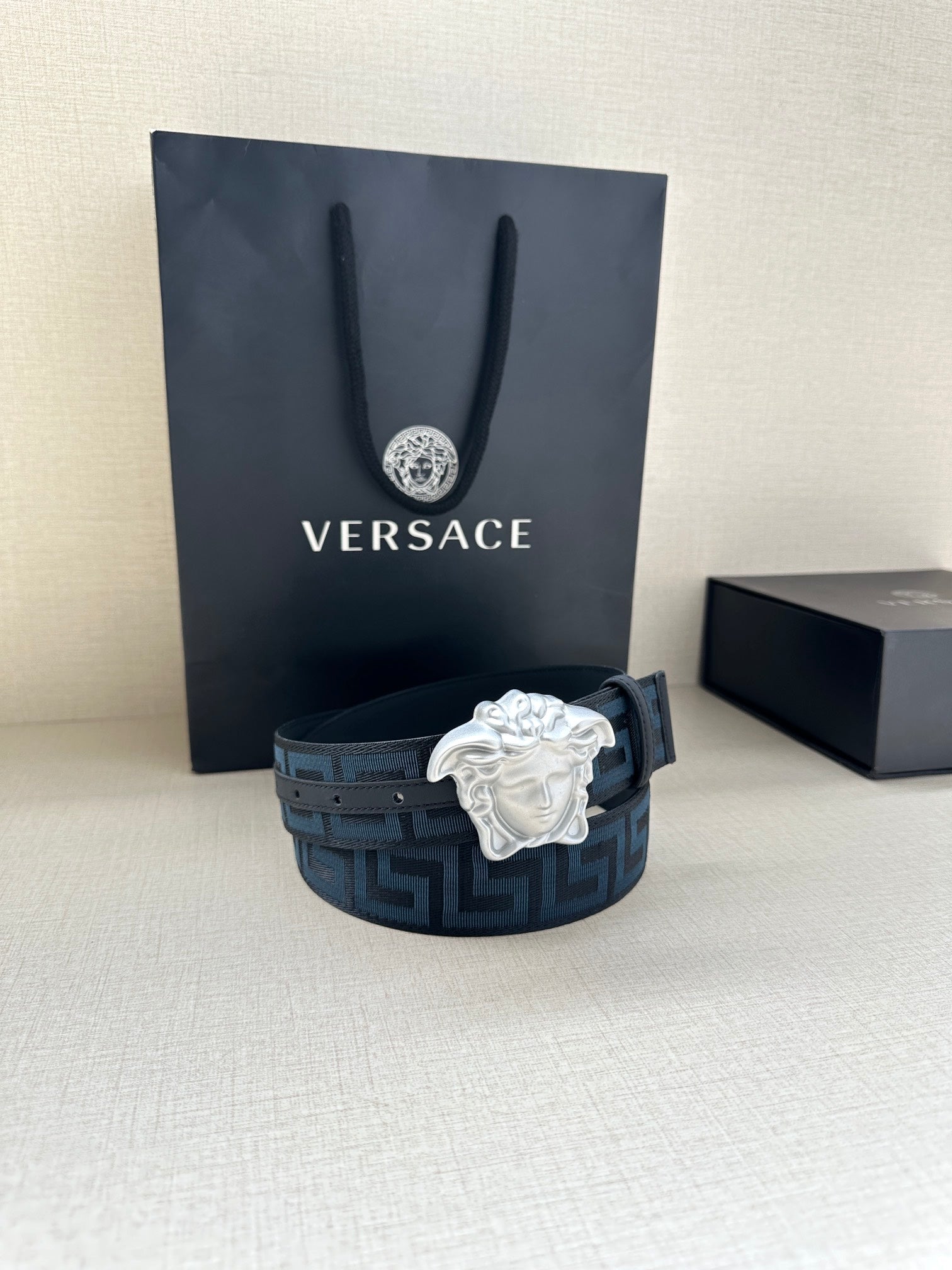 Versace belt, dark blue Greek key strap with silver Medusa head buckle.