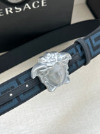 Versace belt detail: dark blue Greek key strap with silver Medusa buckle.