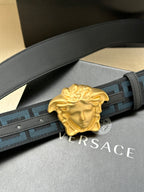 Versace belt close-up: blue Greca webbing and gold Medusa buckle on dark strap