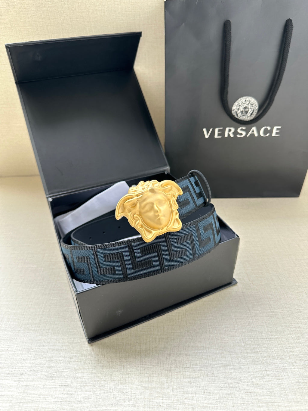 Versace belt with Greca webbing, gold Medusa buckle, shown in open gift box
