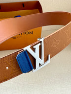 Tan monogram belt with large silver LV buckle and blue leather keeper