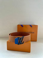 Tan belt with blue LV buckle and embossed texture, with adjustable hole spacing visible