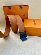 Tan belt strap looped with blue LV buckle and embossed monogram-style texture