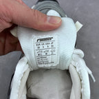 White fabric size tag on athletic sneaker with “EUR/UK/US” and product details