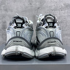 Back view of athletic sneakers with heel tabs, grey trim, and “38” size markings