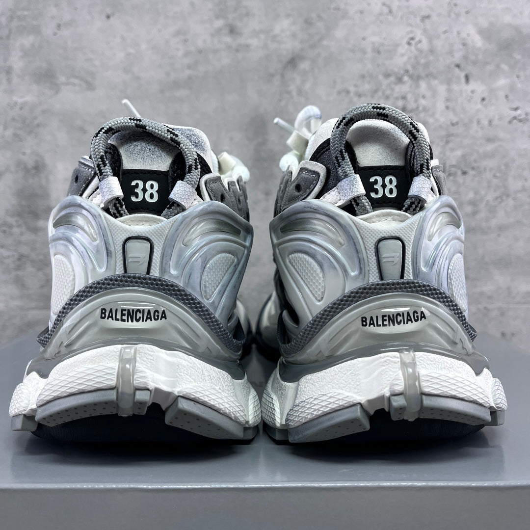 Back view of athletic sneakers with heel tabs, grey trim, and “38” size markings