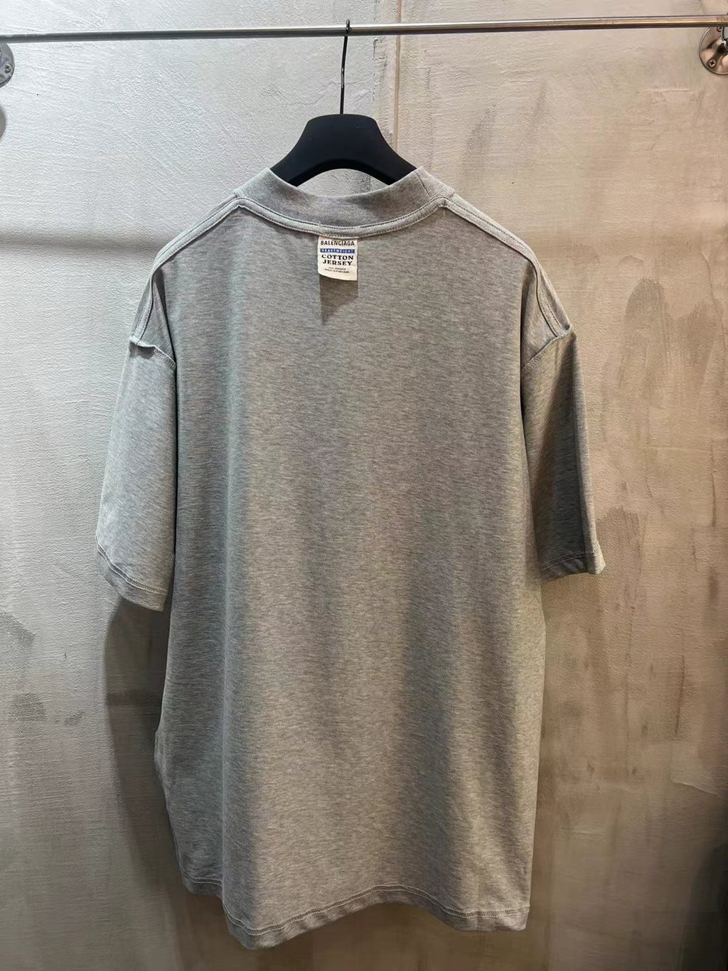Heather gray short-sleeve T-shirt with crew neck and size tag at collar