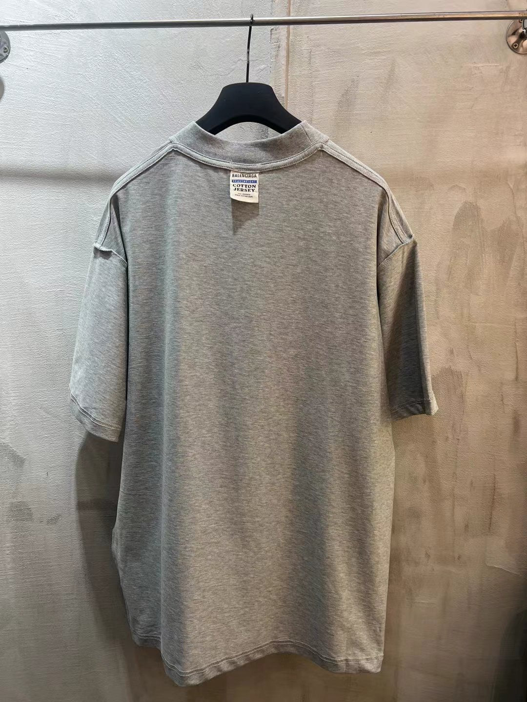 Heather gray short-sleeve T-shirt with crew neck and size tag at collar