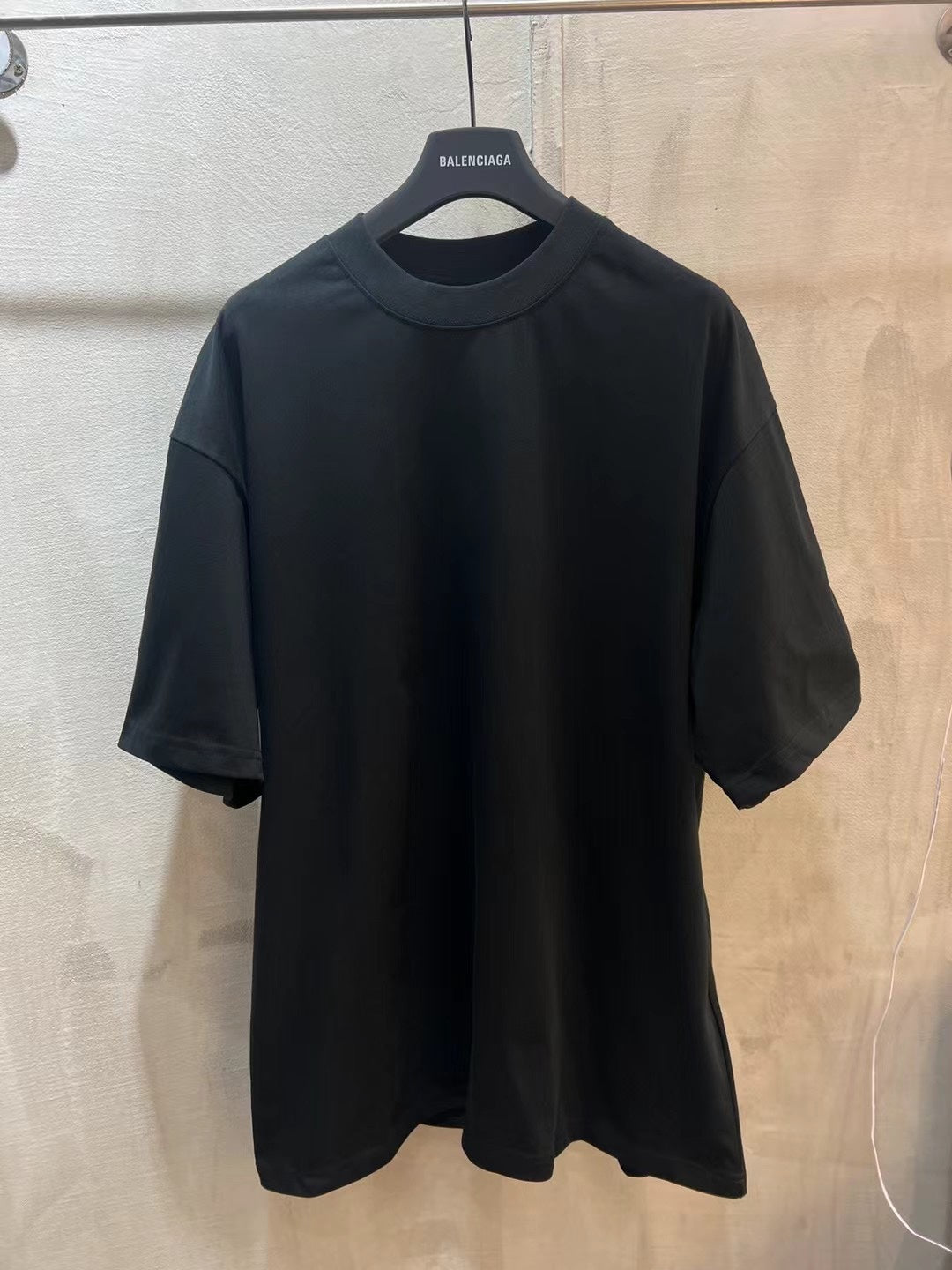 Dark short-sleeve T-shirt with crew neck, no visible front graphic