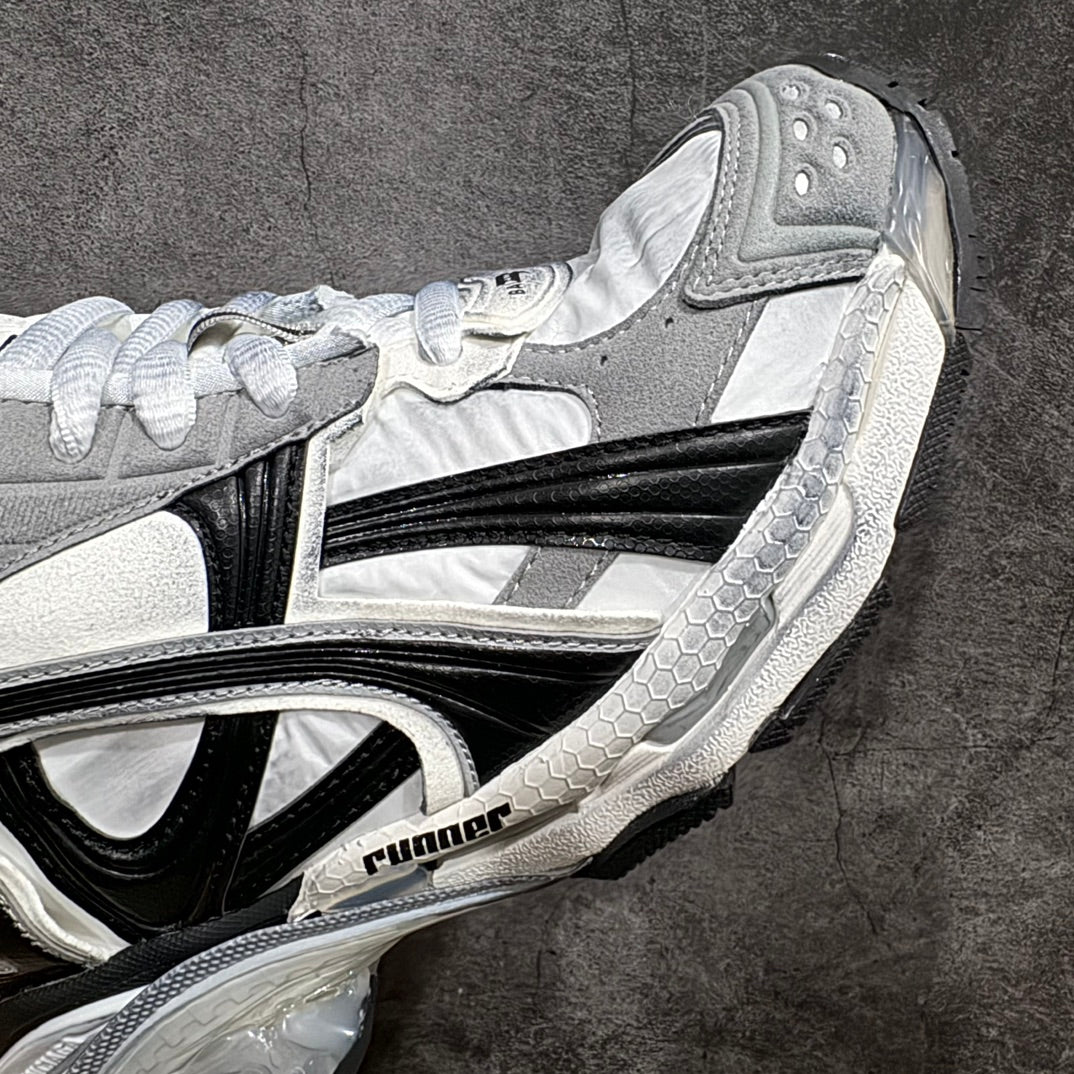 Balenciaga unisex sneaker midfoot detail in white, gray, and black with bold stripe