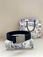 Dior belt with dark leather strap and silver rectangular buckle, resting flat.