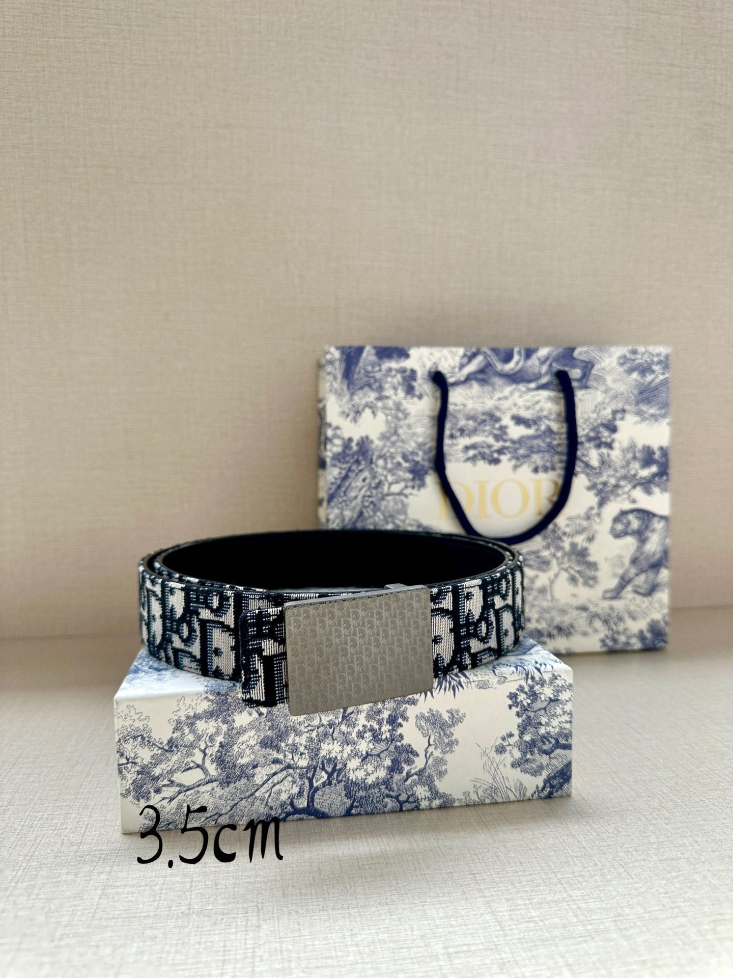 Dior belt laid flat with blue logo jacquard strap and rectangular dark buckle, 3.5cm