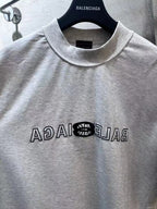 Light gray Balenciaga short-sleeve T-shirt close-up of crew collar and front logo