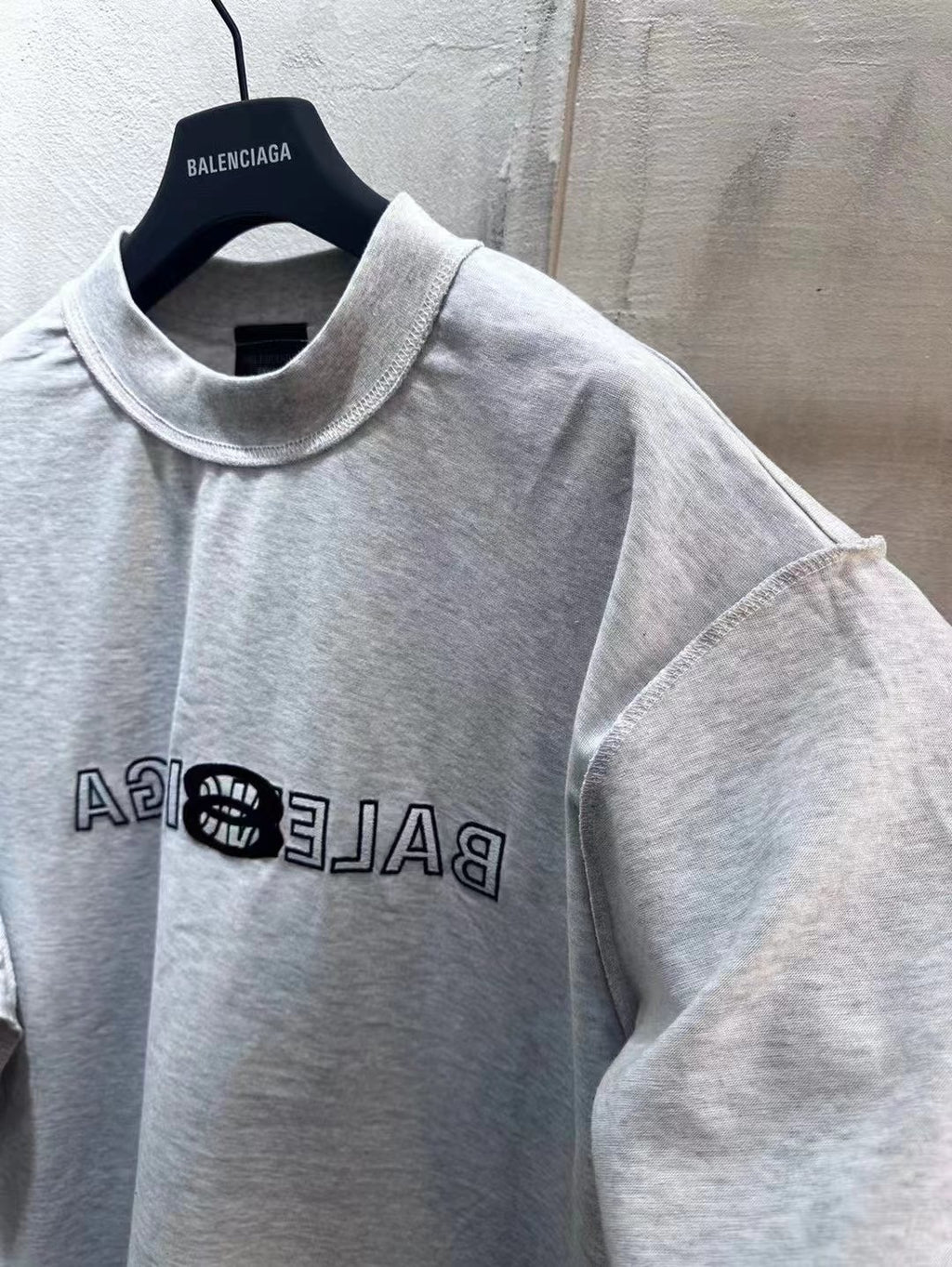 Light gray Balenciaga short-sleeve T-shirt front close-up with logo print on chest