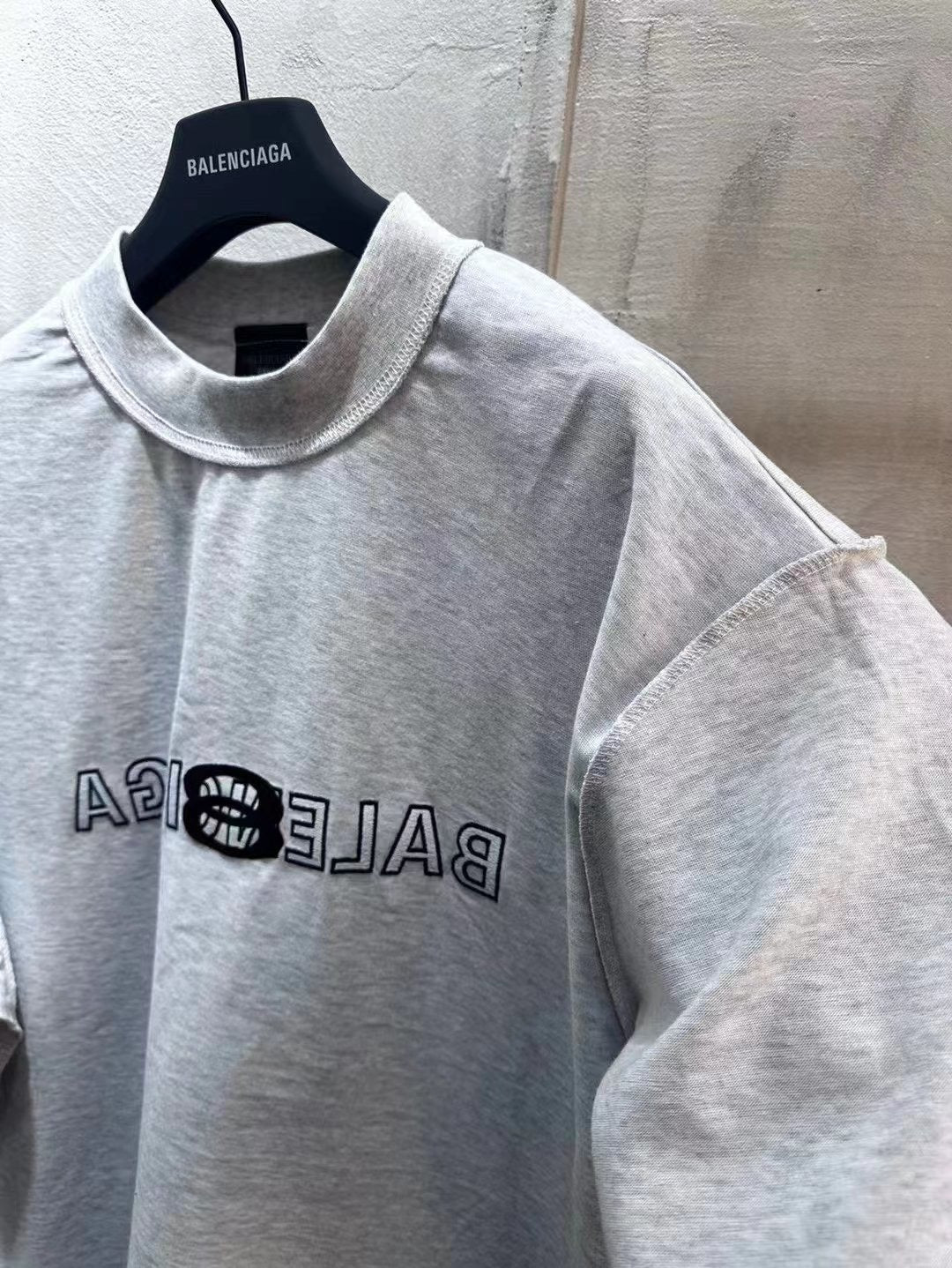 Light gray Balenciaga short-sleeve T-shirt front close-up with logo print on chest