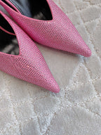 Pink glitter-textured mule upper with pointed toe and stiletto heel, close-up