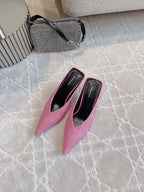 Pink crystal-embellished mules with pointed toe and thin stiletto heels, top view