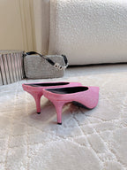 Pair of pink crystal-embellished mules with stiletto heels, rear angle