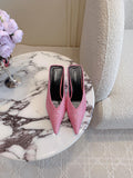 Pink crystal-embellished pointed-toe mules with thin stiletto heel, side view
