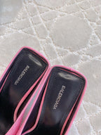 Inner lining of pink mules with pointed toe, black footbed detail