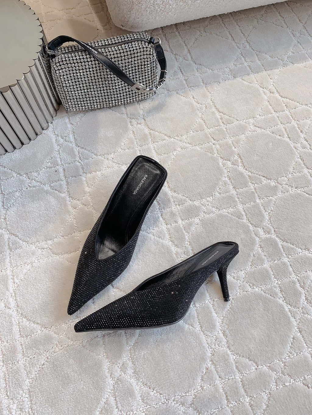 Black Balenciaga pointed-toe mules with stiletto heel, angled view
