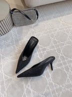 Black Balenciaga pointed-toe mules with stiletto heel, angled view